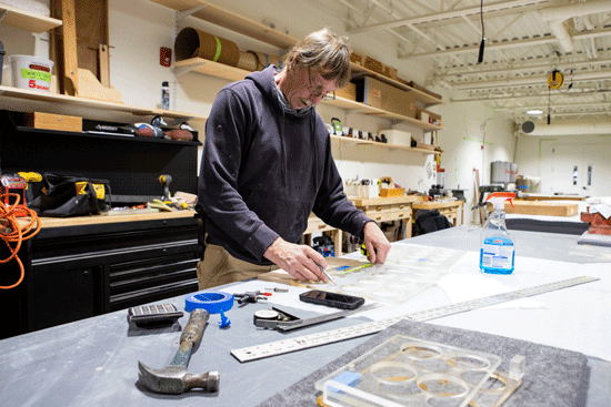 Donnie Pierce of Lyman Morse stencils out custom carpentry for a customer’syacht.