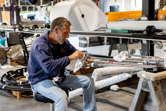 Darrin Low of Lyman Morse prepares a sail’s rod rigging for winter storage