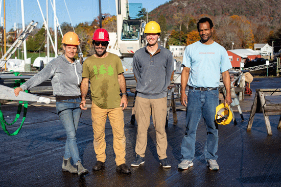 Nicole and Ramiro Acevedo Ramos of the Schooner Surprise pose with Corey and Junior of Lyman Morse after the group successfully unstepped the mast of the schooner as part of the storage-preparation process.