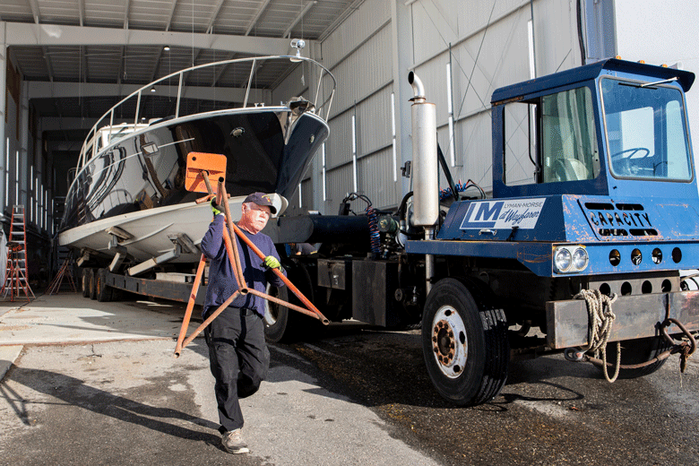 An employee of Lyman-Morse in Thomaston carries a boat stand. PHOTO: JACK SULLIVAN