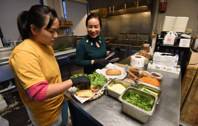 Hoa (Flower) Truong, left, and Hoa Le prepare food.