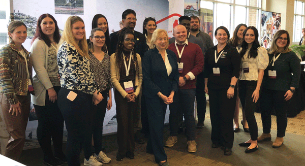 Gov. Janet Mills, center, poses with students and faculty from Husson University’s Hospitality & Tourism master’s program. PHOTO: TOM GROENING