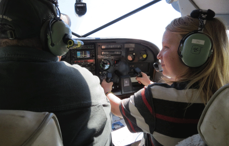 Eleven-year-old Jack Moore flies with the late Kevin Waters of Penobscot Island Air. PHOTO: COURTESY AVERY LARNED