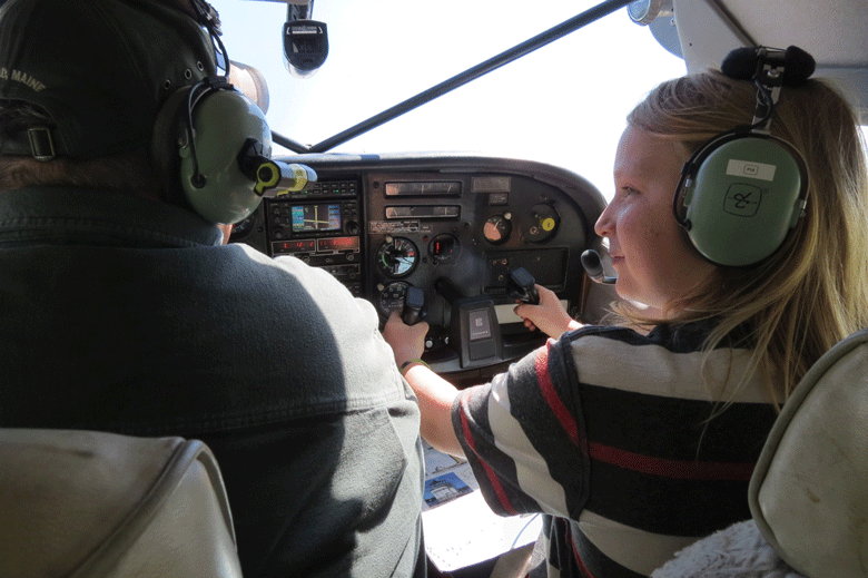 Eleven-year-old Jack Moore flies with the late Kevin Waters of Penobscot Island Air. PHOTO: COURTESY AVERY LARNED