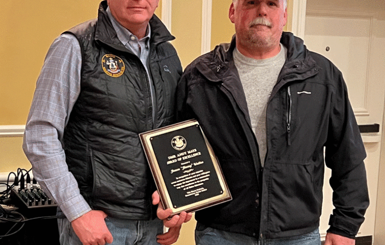 Department of Marine Resources Commissioner Patrick Keliher, left, presents the annual DMR Andy Mays Award of Excellence to Friendship fisherman James "Jimmy" Wotton. The award was presented Saturday at the Fishermen's Forum in Rockport.