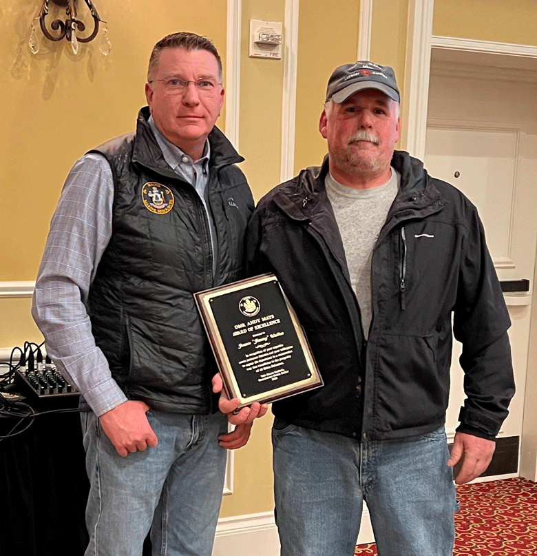 Department of Marine Resources Commissioner Patrick Keliher, left, presents the annual DMR Andy Mays Award of Excellence to Friendship fisherman James "Jimmy" Wotton. The award was presented Saturday at the Fishermen's Forum in Rockport.