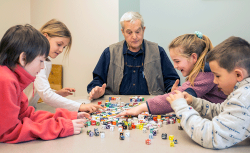 Peter Richards, center, works with (from left) students Bryson Lane, Maevis Bryant, Faith McCarthy, and Noah Hufsey.