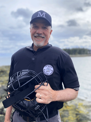 Umpire Pete Rand poses on the Maine coast. PHOTO: SOPHIE PAYSON-RAND