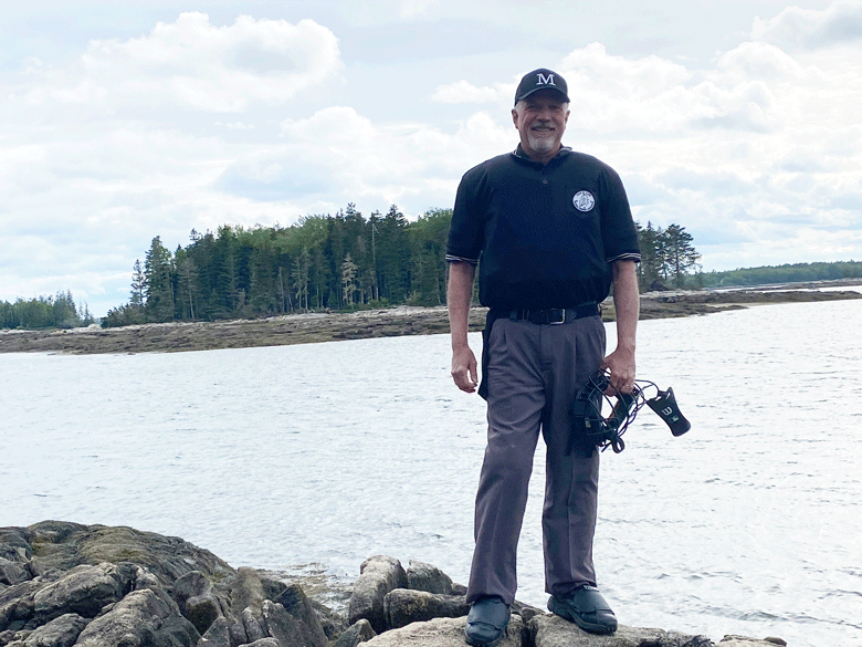 Umpire Pete Rand poses on the Maine coast. PHOTO: SOPHIE PAYSON-RAND