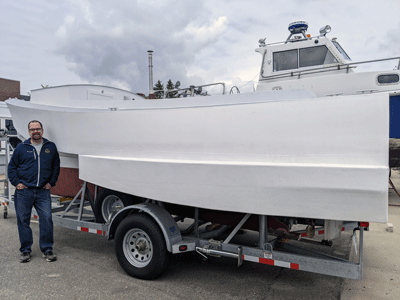Douglas Read poses at Maine Maritime Academy with a multihull prototype.