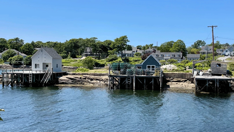 A trio of fish houses and piers on Barleyfield Point, a rocky peninsula that juts out into Lowell’s Cove, Orr’s Island. A lawsuit by one of numerous shareholders seeks to force the others to sell their interest in the property. PHOTO: J.W. OLIVER