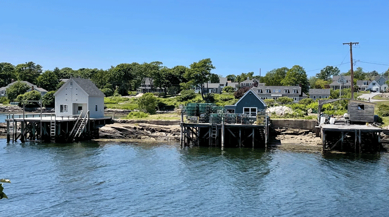 A trio of fish houses and piers on Barleyfield Point, a rocky peninsula that juts out into Lowell’s Cove, Orr’s Island. A lawsuit by one of numerous shareholders seeks to force the others to sell their interest in the property. PHOTO: J.W. OLIVER