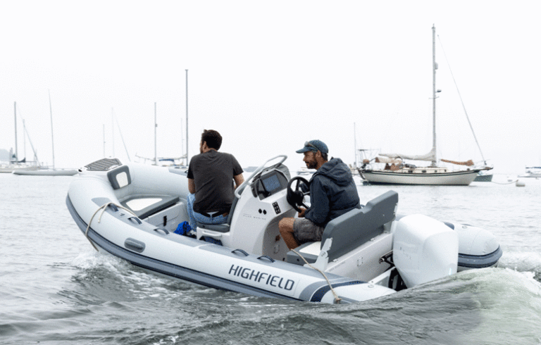 Gabe Pendleton of Pendleton Yacht Yard takes an Island Institute's Alex Kravitz for a spin around Rockland Harbor in a boat powered by a 40-horsepower electric outboard. PHOTO: JACK SULLIVAN