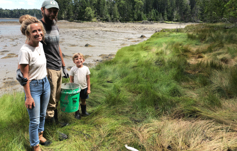 Caitlin and Ethan Spaulding and their son Forrest pose on the shore of their Islesboro farm. PHOTO: TOM GROENING