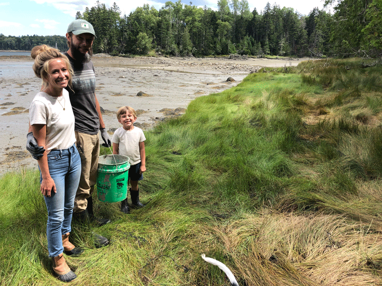 Caitlin and Ethan Spaulding and their son Forrest pose on the shore of their Islesboro farm. PHOTO: TOM GROENING