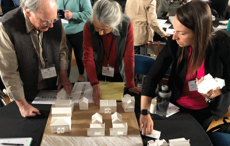 Participants at a Build Maine conference work at creating a hypothetical housing development following a zoning ordinance. PHOTO: TOM GROENING