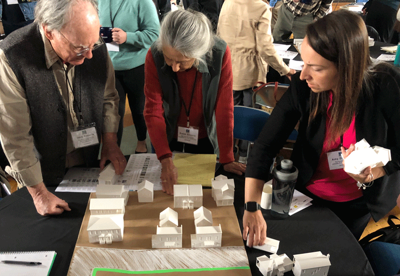 Participants at a Build Maine conference work at creating a hypothetical housing development following a zoning ordinance. PHOTO: TOM GROENING