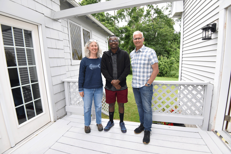 Cristiano Kamnga, center, with Peter and Sue Seraichick.