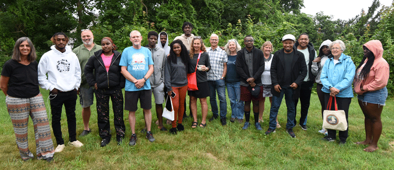 Young immigrants from African countries living the Portland area pose with families on Peaks Island who have hosted the "New Mainers" at their island homes.