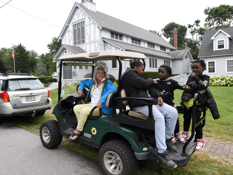 Patty Zimmerman of Peaks Island transports three children from the Mabuie of Mozambique. Several Peaks Island families have taken young people who are recent immigrants from African countries, now living in Portland, into their homes for short- and long-term visits.