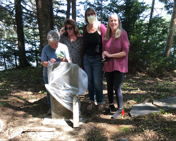 From left, some of those working to clear and preserve the Wadsworth Point Cemetery: Judith Goold, Sally Melrose, Lanette Sigel, and Sally Barrett. PHOTO: TOM GROENING 