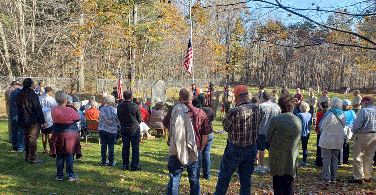 The dedication of a memorial to veterans from the Peterborough community in Warren drew about 100 people. The speaker is Warren’s sexton, Amanda Shelmerdine. PHOTO: STEPHANIE BOUCHARD