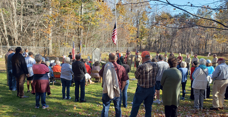 The dedication of a memorial to veterans from the Peterborough community in Warren drew about 100 people. The speaker is Warren’s sexton, Amanda Shelmerdine. PHOTO: STEPHANIE BOUCHARD