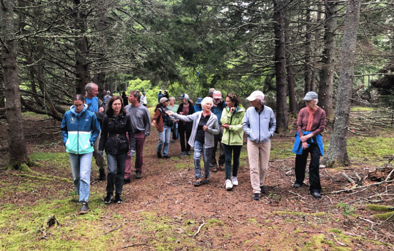 Jody Bush leads participants after an instructional trek through John Bush’s adjacent forest. PHOTO: KATE HOTCHKISS TAYLOR