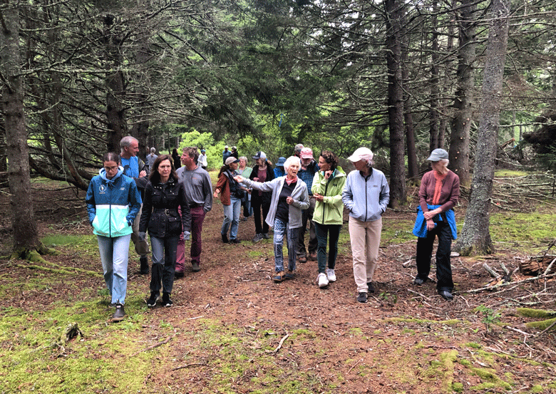 Jody Bush leads participants after an instructional trek through John Bush’s adjacent forest. PHOTO: KATE HOTCHKISS TAYLOR