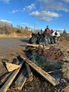 Stephanie Welch, Public Policy Director, cleans up storm debris in Matinicus