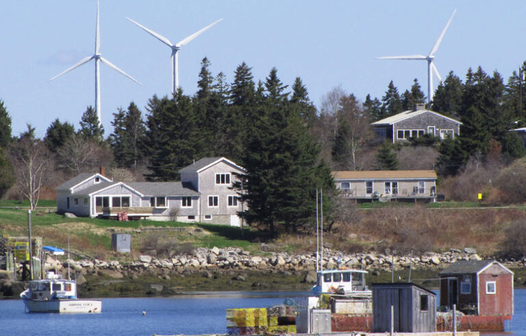 The Fox Island Wind turbines, located on Vinalhaven, appear closer to the shore than they actually are in this image, shot with a telephoto lens. FILE PHOTO: TOM GROENING
