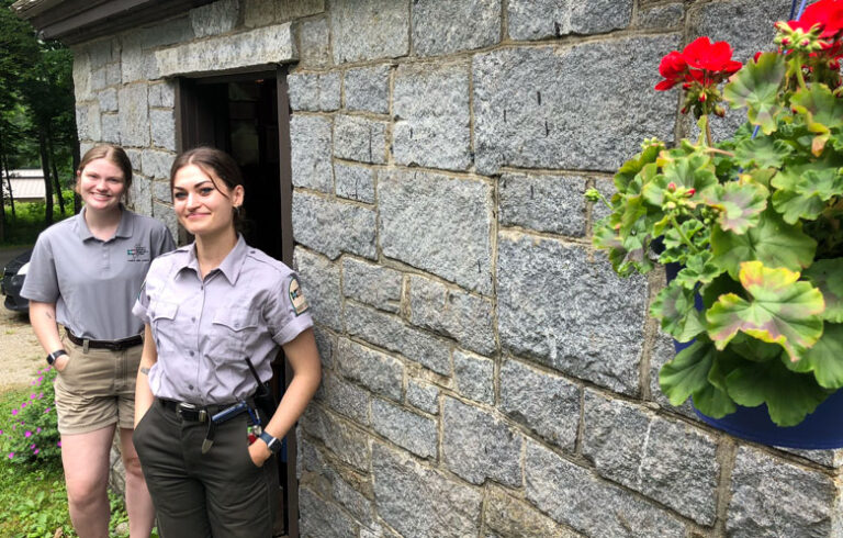 Allison Foust, left, and Arzu Pahl stand by the gatehouse on the east side of Camden Hills State Park, where they work. The gatehouse was built by the Civilian Conservation Corps in the 1930s. PHOTO: TOM GROENING