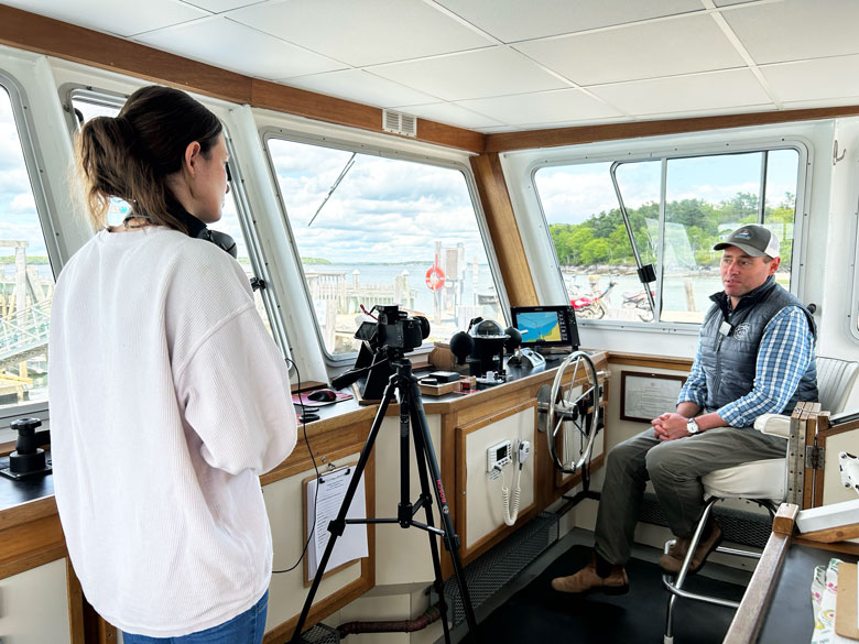 Filmmaker Laura Hamilton interviews Capt. Matt Ridgway general manager of the Chebeague Transportation Co. PHOTO: SUSAN STRANAHAN