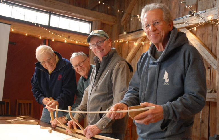 From left, David Wyman, Donald Small, Steve Brookman, and Walt Murphy pose with their 1/16th scale model of the privateer Defence.