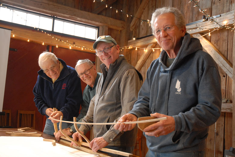From left, David Wyman, Donald Small, Steve Brookman, and Walt Murphy pose with their 1/16th scale model of the privateer Defence.