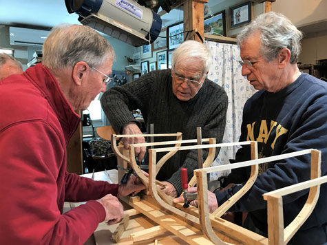 From left, Donald Small, David Wyman, and Steve Brookman work on the model.