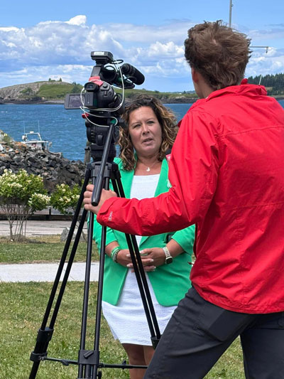 Liz Michaud interviewed by a television reporter.